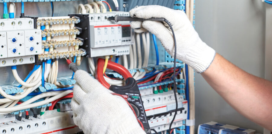 Closeup of an electrician's hand with a diagnostic tool in his hand